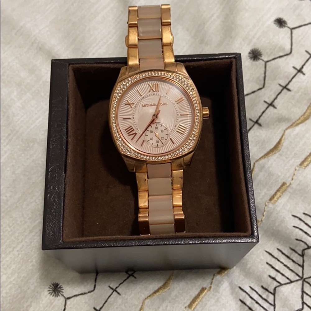 Micheal Kors mother of Pearl band diamond watch.